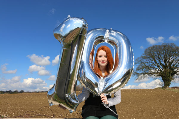 Helium number 10 balloons against blue sky