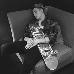 Brooklyn sleeping with his skateboard