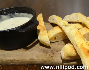 Picture of cheese fondue with slices of bread, ready for dipping
