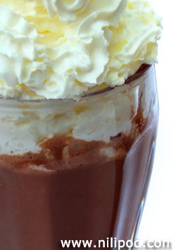 Close-up image of chocolate milkshake with cream