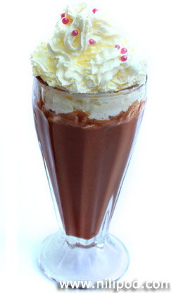 Photo of a chocolate milkshake topped with whipped cream