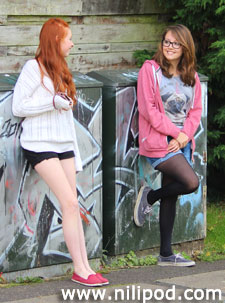 Girls standing by graffiti wall