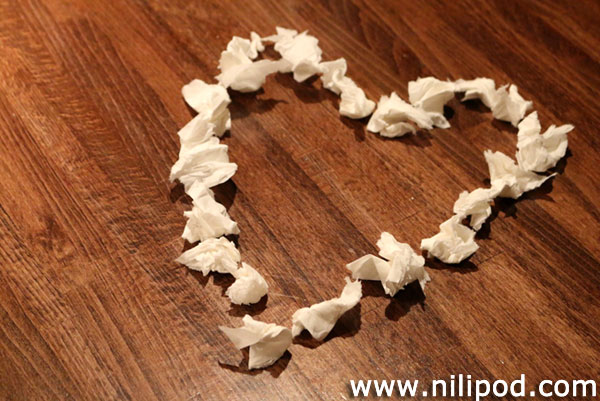 Photo of paper love heart on table
