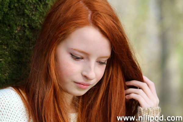 Close=up picture of girl with long red hair