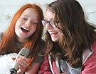 Photo of girls recording podcast