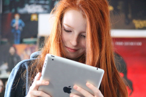Photo of girl using social media on iPad