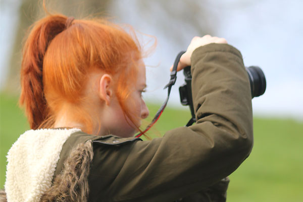Picture of girl with camera taking countryside photos
